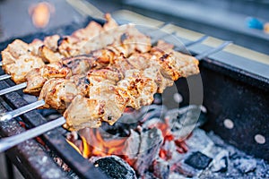 Juicy slices of meat with sauce prepare on fire shish kebab . BBQ outside.