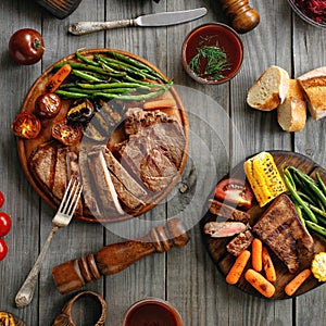 Juicy steak cooked on a grill with grilled vegetables