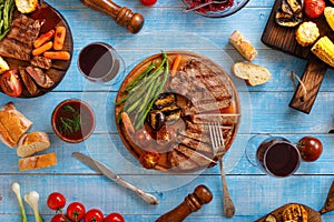 Juicy steak grilled with grilled vegetables and red wine