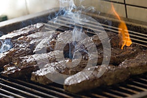 Juicy steak meat grilling on a barbecue