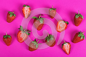 Juicy strawberries on a pink background