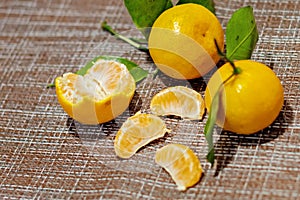 Juicy tangerines with green leaves. Cleaned tangerines. Vitamin C. Healthy vegetarian food