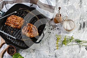 Juicy thick grilled beef steak seasoned with rosemary fresh o viewed from above in a close up view