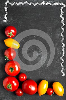 Juicy tomatoes on the black background