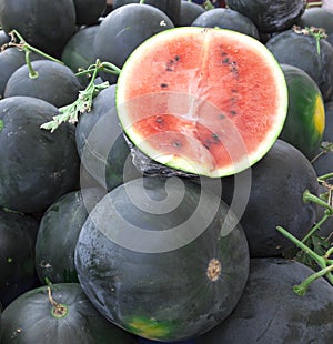 Juicy watermelons. Watermelons at the farmers market of Tunisia.A large slice of ripe juicy watermelon at the village market.