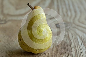 Juicy yellow Bartlett pear on rustic wooden table
