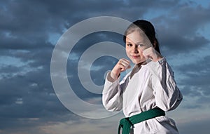 jujitsu girl in kimono on sky background photo