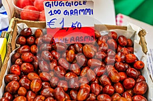 Jujube fruit at a market in Venice, used in Italy to make brodo di giuggiole alcoholic syrup, price tag 1.5 EUR per 100g