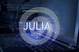 Julia inscription against laptop and code background. Technology concept. Learn programming language