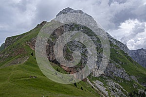 Julian Alps mountain Mangart from Mangrt saddle, Slovenia\'s Highest Panoramic Road, foggy weather