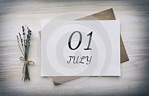 july 01. 01th day of the month, calendar date.White blank of paper with a brown envelope, dry bouquet of lavender