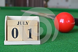 July 01, number cube on snooker table, sport background.