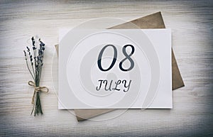 july 08. 08th day of the month, calendar date.White blank of paper with a brown envelope, dry bouquet of lavender
