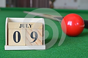 July 09, number cube on snooker table, sport background.