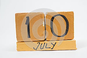 july 10th. Day 10 of month, handmade wood calendar isolated on white background. summer month, day of the year concept