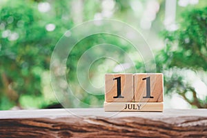 July 11  wooden calendar on vintage wood abstract background. world population day  with copy space for your text