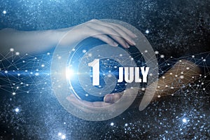 July 1st . Day 1 of month, Calendar date. Human holding in hands earth globe planet with calendar day. Elements of this image