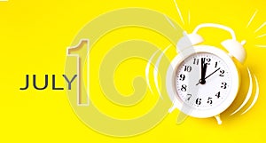 July 1st . Day 1 of month, Calendar date. White alarm clock with calendar day on yellow background. Minimalistic concept of time,