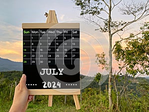 July 2024 calendar with nature background. Stock photo.