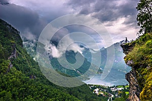 July 24, 2015: Traveller at the Flydalshuvet viewpoint in Geirangerfjord, world heritage site, Norway