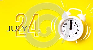 July 24th. Day 24 of month, Calendar date. White alarm clock with calendar day on yellow background. Minimalistic concept of time