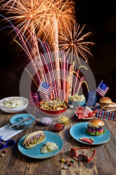 July 4th BBQ table setting with fireworks in background