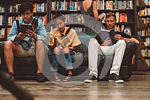 Young man reading a book in the Last Book Store in LA.