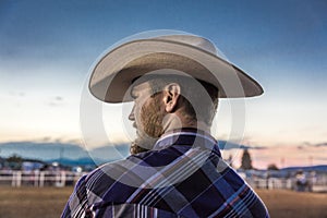 JULY 22, 2017 NORWOOD COLORADO - cowboy in plad shirt watches San Miguel Basin Rodeo, San Miguel. USA, Man