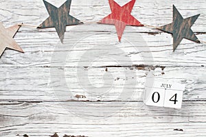 July 4th Calendar Blocks against Rustic Background with Stars photo