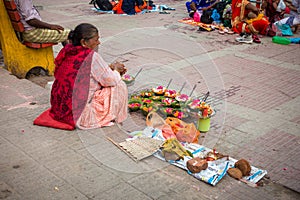 July 8th 2022 Haridwar India. An old lady selling colorful flower basket at the banks or ghats of river Ganges for the Hindu