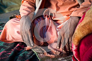 July 14th 2022, Himachal Pradesh India. Closeup of hands of an of an Indian Sadhu in traditional saffron attire during Shri khand photo