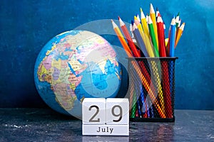 July 29 on the wooden calendar.The twenty-ninth day of the summer month, a calendar for the workplace. Summer photo