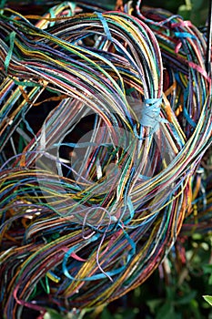 Jumble of exposed utility box muddy and dirty wires vertical