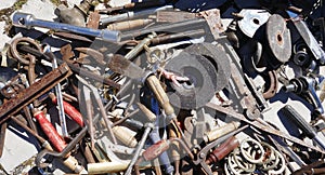 Jumble of old rusty nails and hand tools