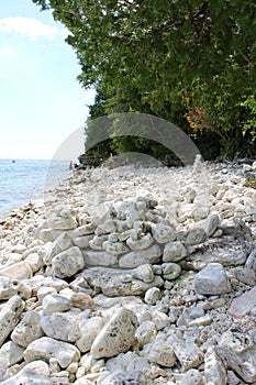 A jumble of white rocks, pebbles and cairns on the shoreline of Lake Michigan in Sturgeon Bay, Wisconsin