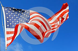 Jumbo beautiful American flag on a flying against a sky