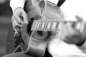 Jumbo guitar in the hands of a musician