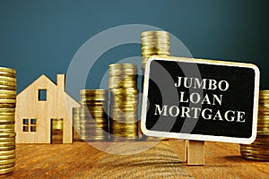 Jumbo Loan mortgage inscription and stacks of coins photo