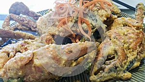 Jumbo mud crab stir fried in salted egg yolk served on a plate as a catering concept