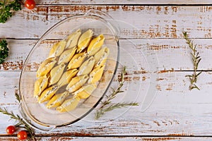 Jumbo pasta shells stuffed with ricotta cheese, meat and sauce in oven pan