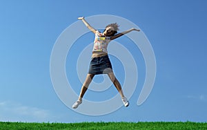 Jump girl over a grass