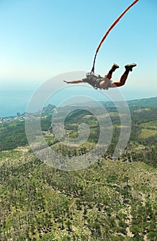 Jump off a cliff with a rope.Bungee jumping