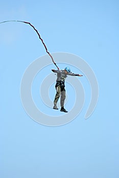 Jump off a cliff with a rope.Bungee jumping