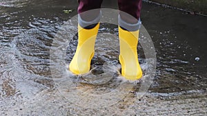 Jump through puddles in yellow rubber boots. Walk in rain and enjoy the bad weather falling into childhood and running through wet