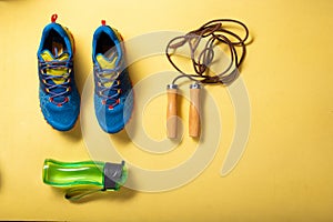 Jump rope for fitness training. Sports sneakers and jump rope. Cardio workout anywhere. Sneakers and water in a flask
