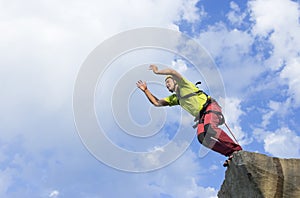 Jump rope from a high rock in the mountains.