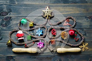 Jump rope or Skipping rope in the form of christmas tree on a white wooden background. Healthy and fitness wellbeing active