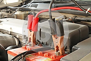 Jumper cables on a car photo