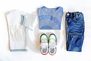 Jumper,t shirt and jeans pants with sneakers. Set of baby children`s clothes and accessories for spring, autumn or summer on whit