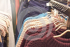 Jumpers of different colors on hangers in the store